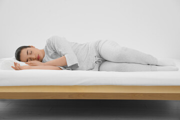 Woman sleeping on memory foam pillow indoors