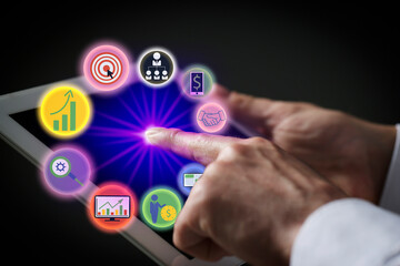 Marketing. Man using tablet against black background, closeup. Virtual icons popping out from device screen