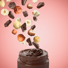 Making yummy chocolate paste. Hazelnuts and pieces of chocolate falling into jar on pale red background