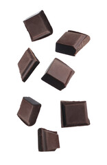 Pieces of chocolate bar falling on white background