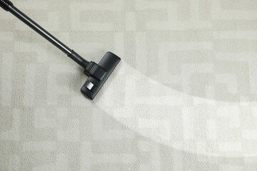 Hoovering carpet with vacuum cleaner, top view and space for text. Clean trace on dirty surface