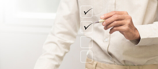 Businessman use pen and tick correct sign mark to management checklist process for product control...