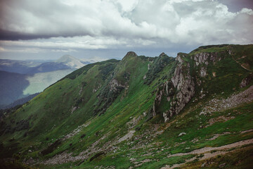A breathtaking panorama of the majestic Carpathian Mountains in Ukraine, showcasing rugged peaks, lush green valleys, and expansive skies