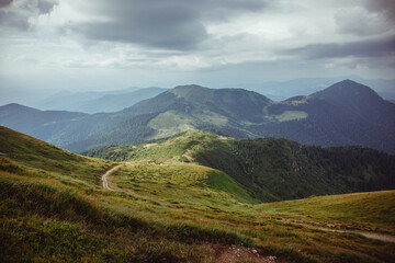A breathtaking panorama of the majestic Carpathian Mountains in Ukraine, showcasing rugged peaks, lush green valleys, and expansive skies