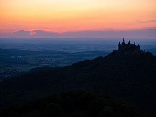 castle silhouette on the mountain at sunset