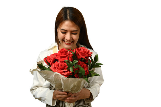 Image of charming and feminine young woman holding beautiful bouquet over white background