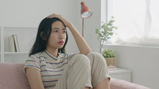 Loneliness. Asian teen girl crying  have emotional mental problems sad, stress, at home