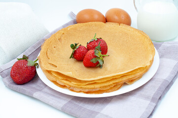 Pancakes with strawberries and ingredients for cooking