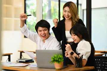 Fototapeta premium Excited business team making yes gesture, celebrating corporate achievement. Business, teamwork, success and winning concept