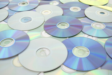 Lots of old CDs are laid out as a background.
