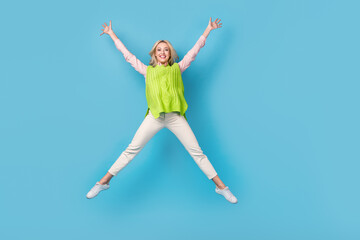 Fototapeta na wymiar Full length portrait of overjoyed gorgeous person jumping make star figure isolated on blue color background