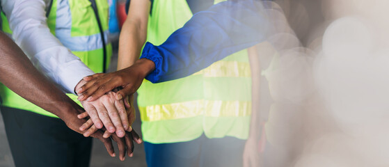 Team engineers and foreman stack hand and shake hands to show success at factory machines. Worker industry join hand for collaboration.
