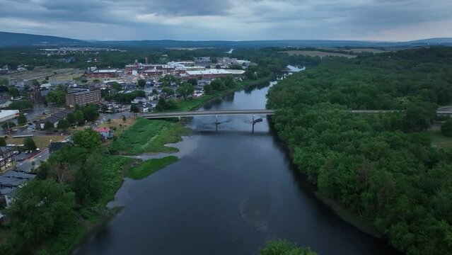 Susquehanna River and downtown Milton, Pennsylvania with drone video moving in and spinning.