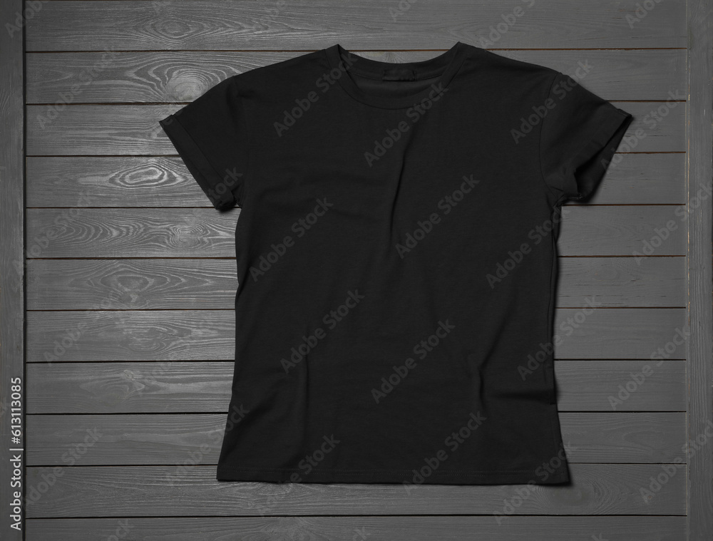 Wall mural Stylish black T-shirt on gray wooden table, top view - Wall murals
