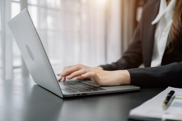 working on laptop, close up of hand of business  women.
