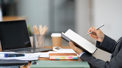 Business Documents concept : Businesswoman writing note while sitting at desk office.