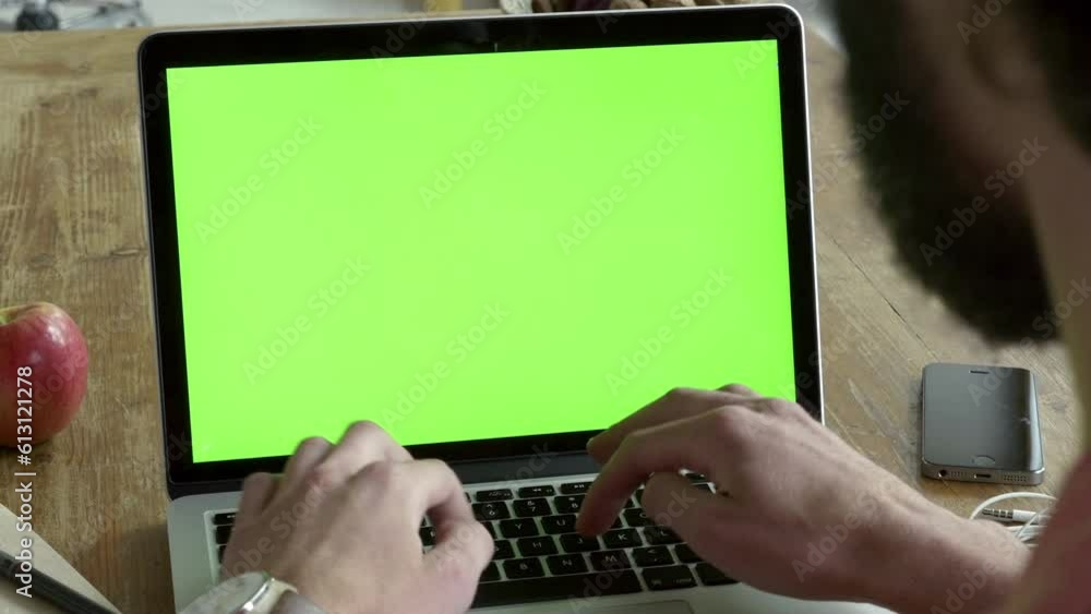Poster young adult man is working with modern laptop. he is typing on keyboard and press enter button. work