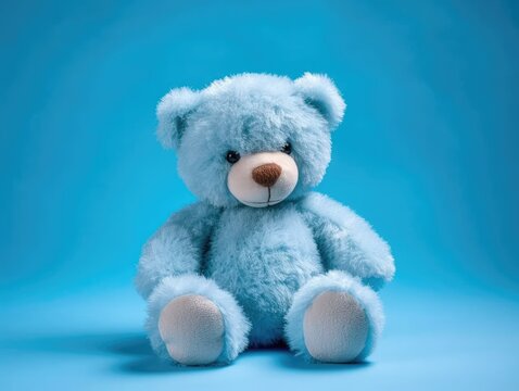 Naklejka Blue teddy bear on blue background with copy space for your text, cuddly stuffed animal. Baby shower for newborn. generative AI