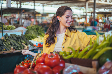 Woman on the market. Mature Female Customer Shopping At Farmers Market Stall. Woman shopping at the local Farmers market. Beautiful woman buying vegetables.