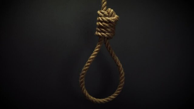 Rope noose with hangman knot on dark background, death penalty concept