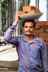 portrait of Indian asian male construction worker or labour working at site