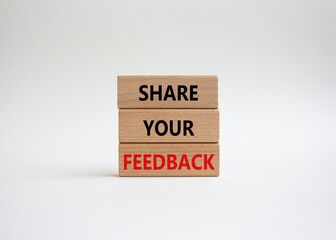 Feedback symbol. Concept word Share your feedback on wooden blocks. Beautiful white background. Business and Ask for feedback concept. Copy space