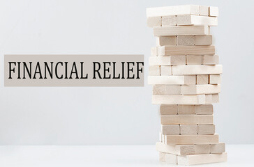 FINANCIAL RELIEF text with wooden block stack on white background , business concept