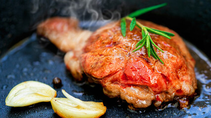 Grilled Wagyu fillet steak and rosemary on hot iron plate. Prime beef fry on electric roaster.