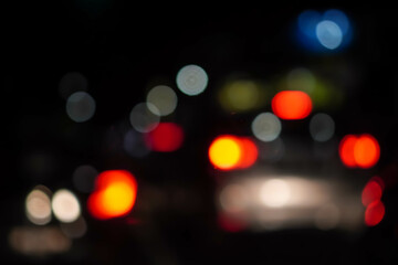 Blurred colorful city and vehicle car motorcycle lights at night. Defocused colorful lights. Bokeh image with black or dark background.