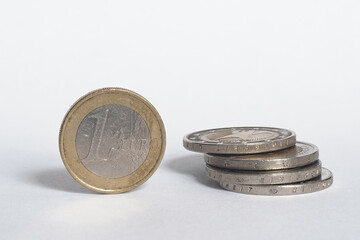 European Union coins stacked on top of each other on a white background. Money in the European Union - Euro