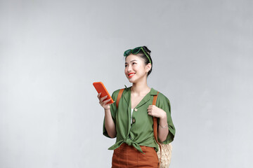 young woman traveler using cell phone searching online information planning to travel.