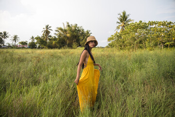 girl wearing a yellow dress and a hat