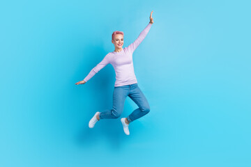Fototapeta na wymiar Full length body cadre of young girl jump fly arms wings careless have fun playing shopping deal advert isolated on blue color background