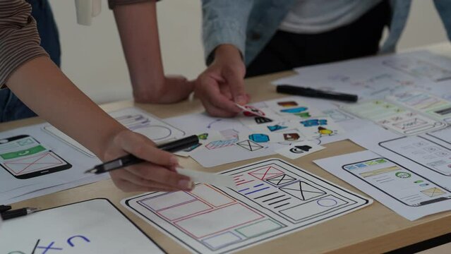 Close up ux developer and ui designer brainstorming interface wireframe design.Creative digital development agency