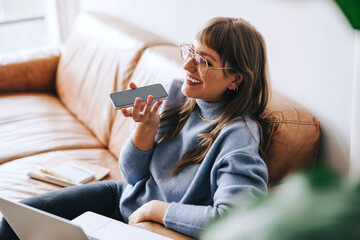 Happy business woman having a phone call in a modern office