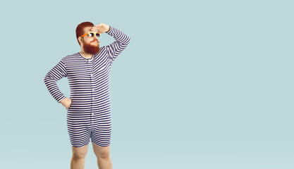 Funny serious chubby man in striped summer leotard looks away on pastel light blue background....