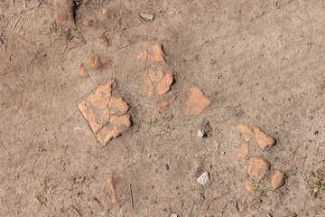 Ground road with fine gravel and broken brick. View from the top. Close-up Background