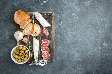 Slices of delicious spanish sausage fuet on a dark background. banner, menu, recipe place for text, top view