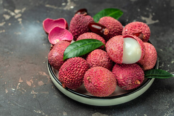 lychees, Ripe lychee. Exotic asian fruits on a dark background, Long banner format. top view