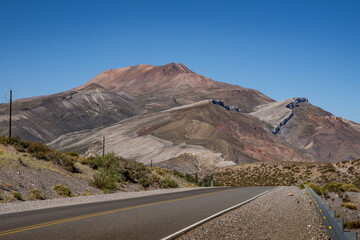 route in argentine patagonia with a colorful mountain in the background
