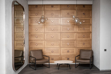 Modern waiting area interior in a mini hotel with a coffee table and two armchairs, hostel lobby...