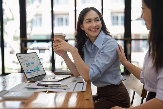 Asian Business team makes analysis and research financial report at office, analyzes profits. Accountant checks status of financial