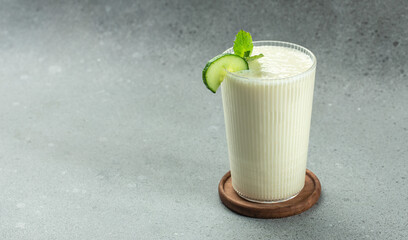 ayran drink with mint and cucumber on a white background, clean eating for weight loss. place for...