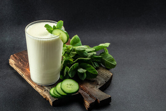 Ayran or Doogh is a popular refreshing yogurt on a dark background. Restaurant menu, dieting, cookbook recipe top view
