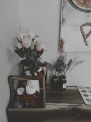 A photograph of flowers and sauces in gray tones.