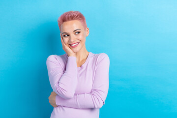 Portrait of good mood pretty girl with stylish hair dressed pink shirt look empty space arm on...