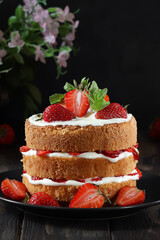 Elegant strawberry layer cake with fresh berries and cream.