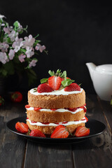Cake with strawberry on the black background.