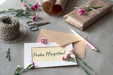 Text Frohe Phingsten means Happy Pentecost in German language. Envelope and greeting card with...