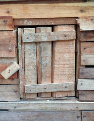 The traditional free-range chicken dwelling is made of brown wood, the cage is at the back of the house